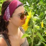 A woman smelling a sunflower