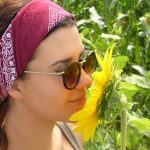 A woman smelling a sunflower